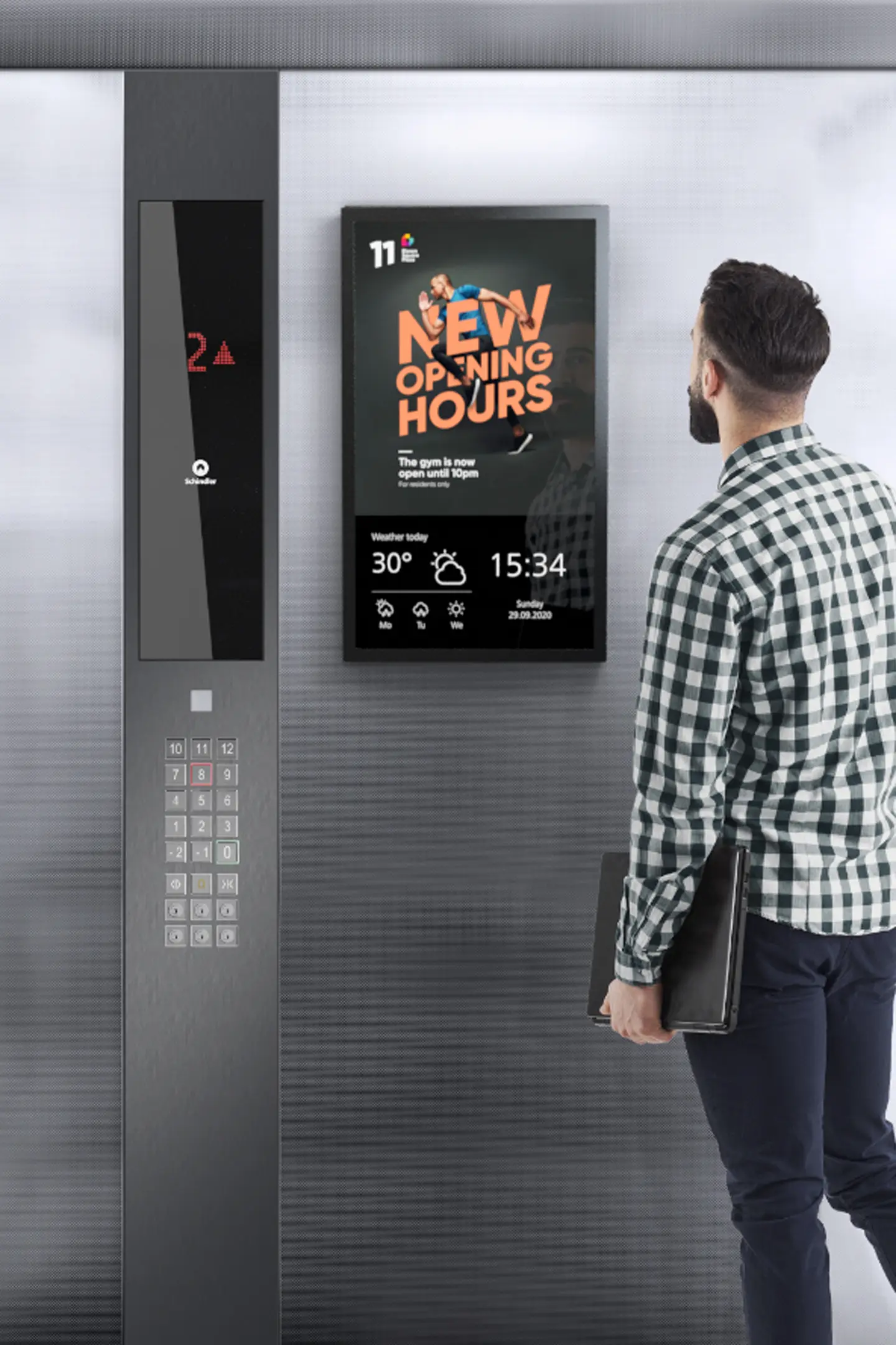 Digital screen advertising inside a modern office elevator