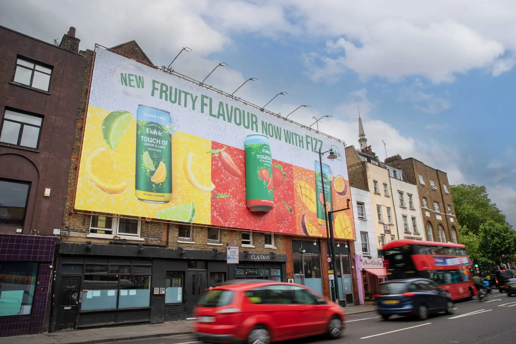 Large-format building billboard with 3D creative on a busy London street