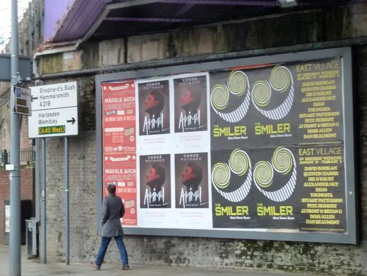Legal flyposting boards with layered campaign posters