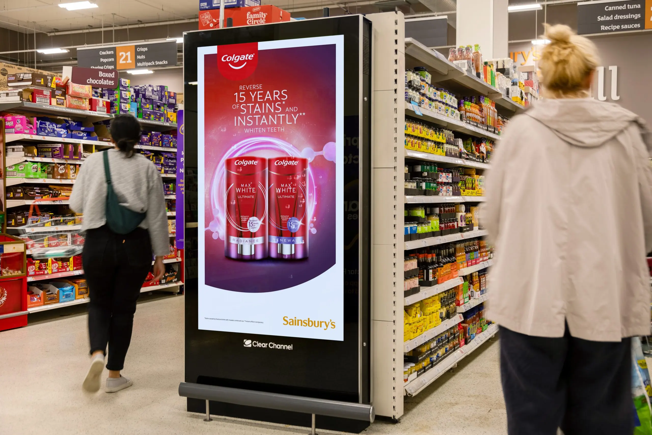 Digital advertising screen at a supermarket aisle end