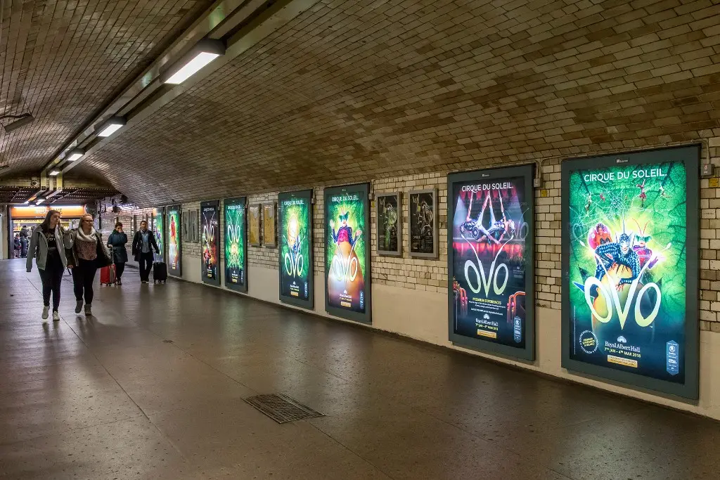 Static backlit poster formats lining an Underground corridor