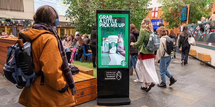 Digital totem advertising screen in a university student association space